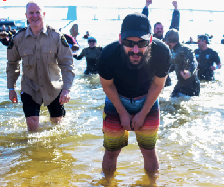 Former AACC communications student Michael Garvey takes the Polar Bear Plunge with some AACC public safety officers in 2018. A new campus club is gathering current students to do it in February. 
